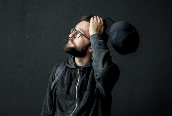 man looking up holding his hair