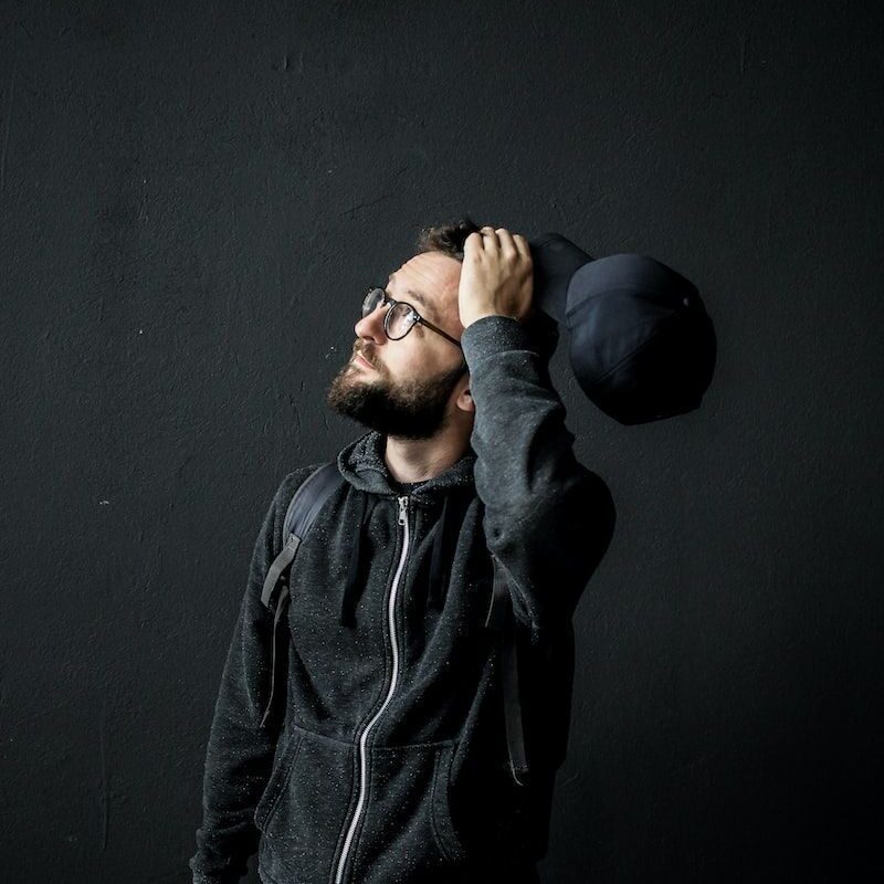 man looking up holding his hair