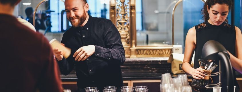 photo of man and woman mixing beverages