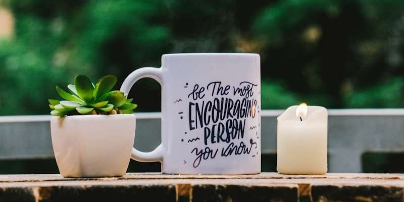 shallow focus photography of white mug and succulent plant on table